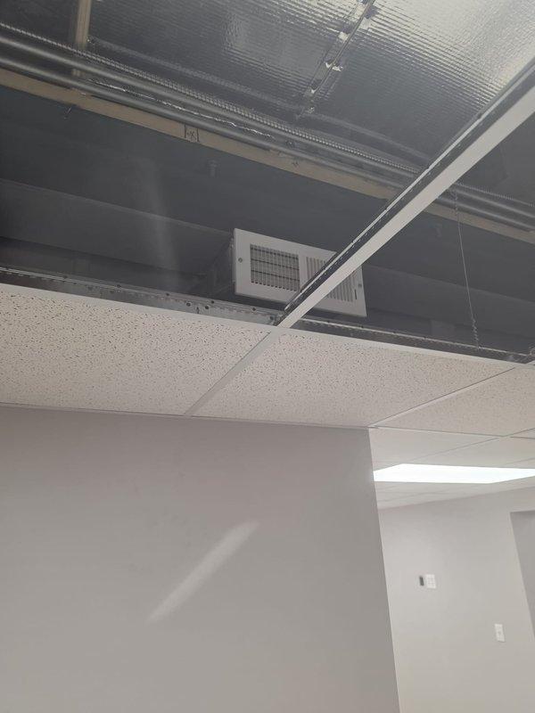 Completed HVAC ductwork installation and air distribution system setup for commercial new construction project. Installed rectangular sheet metal supply and return ductwork in ceiling plenum space with proper insulation and reflective barriers, mounted supply register grilles to ductwork for air distribution, and coordinated installation with ceiling grid system to ensure proper integration with acoustic tile ceiling. All ductwork secured to structural elements and positioned to allow adequate clearance for ceiling tile installation and future access.