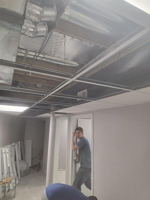 Completed HVAC ductwork installation and air distribution system setup for commercial new construction project. Installed rectangular sheet metal supply and return ductwork in ceiling plenum space with proper insulation and reflective barriers, mounted supply register grilles to ductwork for air distribution, and coordinated installation with ceiling grid system to ensure proper integration with acoustic tile ceiling. All ductwork secured to structural elements and positioned to allow adequate clearance for ceiling tile installation and future access.