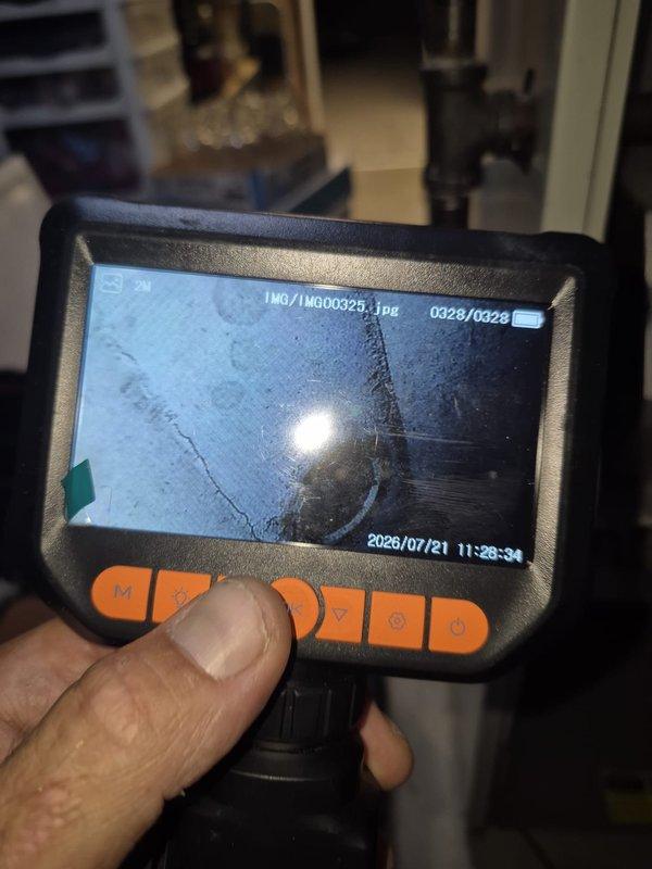 Responded to no-cooling complaint on 26-year-old residential air conditioning system. Performed diagnostic inspection using borescope camera to examine internal ductwork and system components for potential failures. Investigation focused on blower assembly and compressor operation as reported problem areas, with visual documentation of interior conditions to identify defects or obstructions affecting system performance.