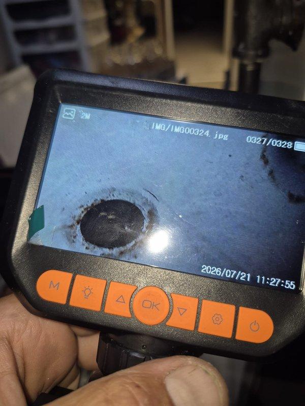 Responded to no-cooling complaint on 26-year-old residential air conditioning system. Performed diagnostic inspection using borescope camera to examine internal ductwork and system components for potential failures. Investigation focused on blower assembly and compressor operation as reported problem areas, with visual documentation of interior conditions to identify defects or obstructions affecting system performance.