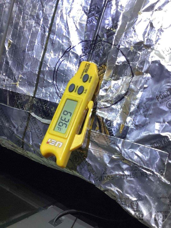 Performed diagnostic evaluation on commercial air conditioning system. Measured and recorded temperature readings using digital instrumentation, obtaining reading of 63.3°F at evaporator coil area. Reviewed unit wiring schematic and control sequence for ML196 series heating unit to verify proper electrical connections and safety device integration including flame rollout switch, pressure switches, and integrated furnace control board.