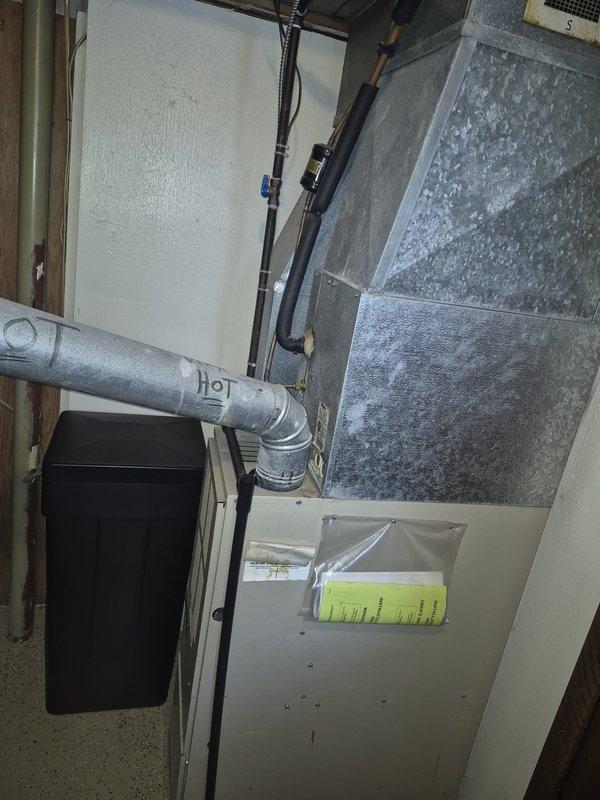 Responded to service call for air conditioning system not producing cold air. Upon arrival, performed diagnostic inspection of outdoor condenser unit and indoor air handler system. Inspected electrical connections at disconnect box, verified proper power supply to equipment, and checked refrigerant lines for leaks or restrictions. Evaluated condenser fan operation and compressor functionality. Examined indoor air handler cabinet, ductwork connections, and airflow distribution system in mechanical space. System components inspected and operational status verified to restore cooling performance.