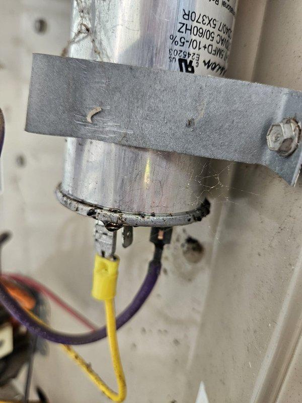 # HVAC Service Call - No Cooling Issue

Responded to service call for 22-year-old air conditioning unit with no cooling complaint. Upon arrival, performed system diagnostic to identify cause of failure.

Inspected outdoor condensing unit and found failed dual run capacitor preventing compressor and condenser fan motor operation. Capacitor showed visible signs of deterioration and tested out of specification range using multimeter. This is a common failure point on units of this age due to normal wear and extended service life.

Removed defective capacitor from mounting bracket and disconnected all electrical connections including common, compressor, fan, and HERM terminals. Installed new dual run capacitor with proper microfarad rating matching manufacturer specifications for the equipment. Reconnected all electrical wiring to appropriate terminals ensuring proper color coding and secure connections.

Restored power to unit and verified compressor and condenser fan motor startup. Monit