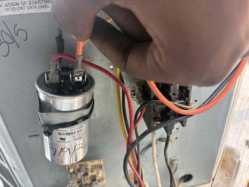Responded to callback for non-operational air conditioning system. Inspected electrical components including capacitor and contactor assembly. Verified proper wire connections at capacitor terminals and checked contactor operation. Tested system startup and confirmed unit returned to normal cooling operation.