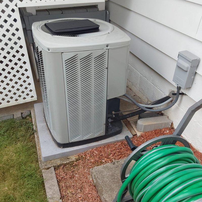 Completed full HVAC system retrofit including installation of new Trane XRBO high-efficiency furnace and matching outdoor condensing unit. Installed furnace in utility area with proper PVC intake and exhaust venting, connected to existing ductwork via air handler cabinet with metallic flexible transition. Positioned new beige condenser unit on existing concrete pad with proper clearances, installed electrical disconnect box on exterior wall, and completed all electrical connections per manufacturer specifications. System tested and verified operational with all safety controls functioning properly.