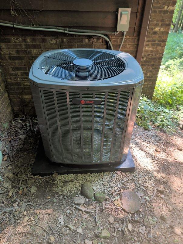 Completed AC retrofit installation of new Trane 3-ton condenser unit (Model 5TTR3060A1000A, Serial 2623374YGF) and matching evaporator coil (Model 5TXCC007AS3HCA, Serial 26271LAECG). Installed condenser on concrete pad against exterior brick wall with proper clearances, ran refrigerant lines with seal-tight conduit, charged system with R-410A refrigerant, and performed startup procedures to verify proper operation of all components.