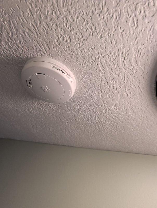 Installed intake piping for residential furnace system, with exterior PVC intake termination visible at foundation level. Installed three combination smoke and carbon monoxide detectors throughout the residence to ensure proper life safety protection and code compliance.