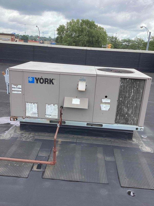 Completed scheduled commercial cooling maintenance on York rooftop packaged unit. Performed comprehensive inspection of all accessible components including condenser coil section, refrigerant lines, and internal mechanical systems. Accessed equipment compartments to verify proper operation and condition of internal components. Unit operating within normal parameters with no immediate service needs identified at time of inspection.