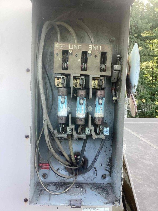 Responded to no cooling call on commercial air conditioning system. Upon arrival, inspected outdoor electrical disconnect and found three cartridge fuses severely corroded with visible oxidation and discoloration. Fuse holders showed signs of moisture intrusion and weathering, with significant debris accumulation inside disconnect enclosure. Electrical connections exhibited corrosion damage that compromised system power supply, resulting in complete loss of cooling. Documented conditions with photos showing extent of deterioration to electrical components and safety disconnect box.