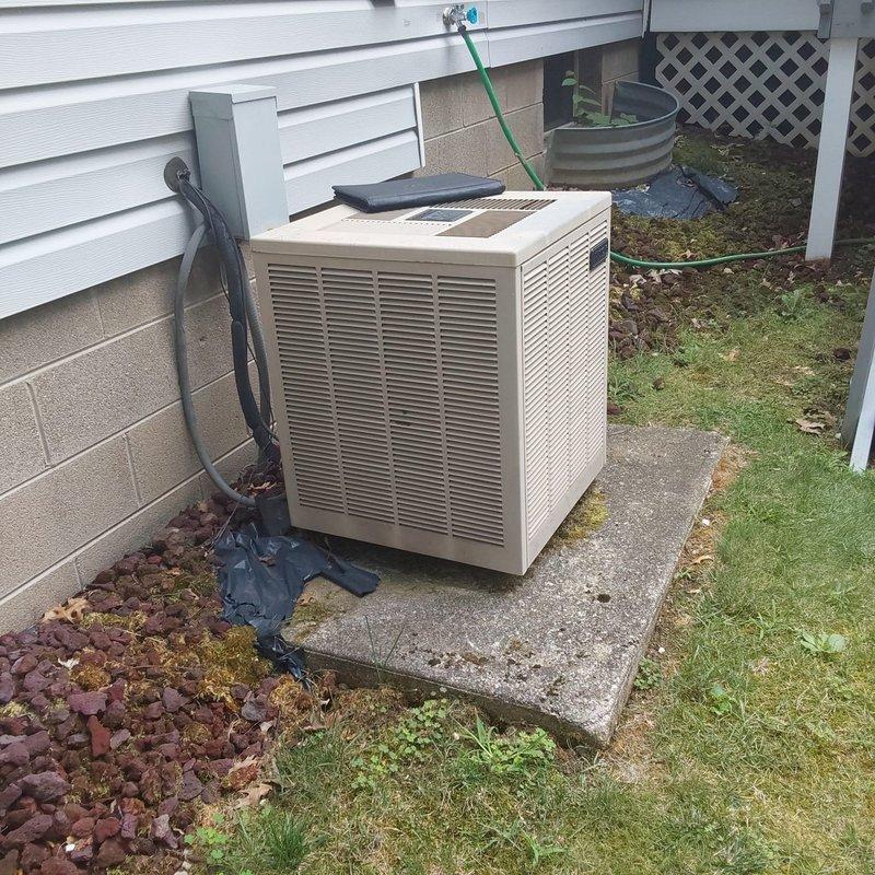Completed comprehensive HVAC system evaluation for furnace and air conditioning retrofit installation. Assessed existing equipment configuration in basement mechanical room, including furnace unit with internal components, ductwork connections, and gray sheet metal air handler assembly. Evaluated outdoor condenser unit positioned on concrete pad with refrigerant line routing along exterior wall, confirming proper placement and clearances for optimal system performance.