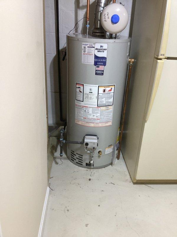 Installed a new 40-gallon tall Bradford White gas water heater in utility room, including all necessary copper piping connections, expansion tank, pressure relief valve, and proper venting components. Unit was delivered from SupplyHouse and successfully installed with all plumbing connections tested and verified for proper operation.