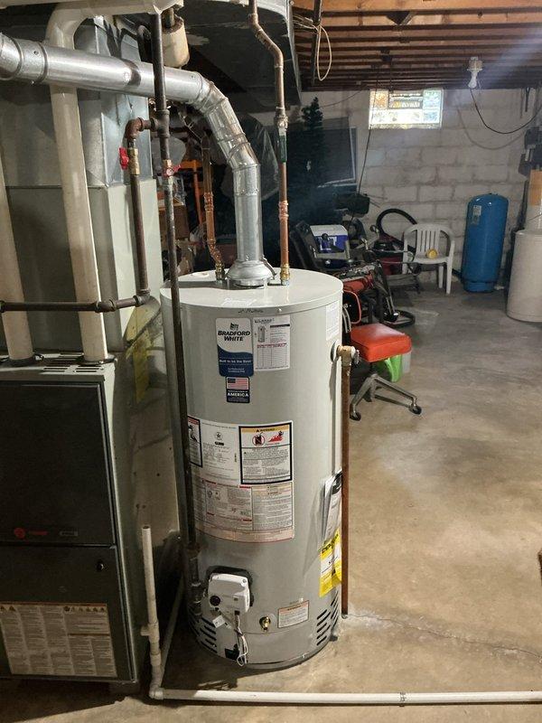 Responded to customer complaint regarding odor emanating from water heater. Customer approved replacement of existing anode rod with odor-reducing nano-rod to eliminate sulfur smell caused by bacteria interaction with standard magnesium anode. Coordinated part delivery and scheduled replacement of anode rod in Bradford White residential water heater unit located in basement mechanical room. Documented existing water heater installation and plumbing connections prior to service completion.