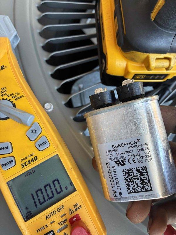 Performed scheduled commercial cooling maintenance on rooftop HVAC unit. Tested and evaluated dual-run capacitor using digital multimeter, confirming proper electrical specifications and functionality within manufacturer tolerances. Removed exterior access panel and inspected evaporator coil filter, which showed heavy accumulation of dirt, dust, and debris significantly restricting airflow. Documented equipment condition through diagnostic photography for maintenance records and future reference.