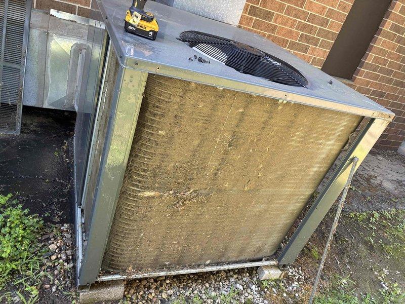 Performed scheduled commercial cooling maintenance on rooftop HVAC unit. Tested and evaluated dual-run capacitor using digital multimeter, confirming proper electrical specifications and functionality within manufacturer tolerances. Removed exterior access panel and inspected evaporator coil filter, which showed heavy accumulation of dirt, dust, and debris significantly restricting airflow. Documented equipment condition through diagnostic photography for maintenance records and future reference.