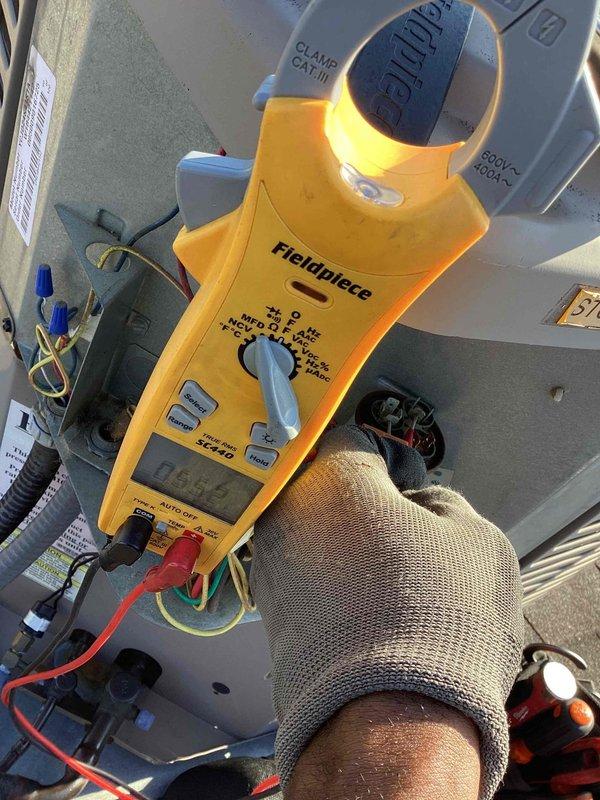 Responded to service call for dual commercial A/C system with one non-operational unit. Performed diagnostic testing using clamp meter to measure electrical values at the affected unit. Inspected capacitor, contactor, and associated wiring connections. Identified faulty MARS capacitor with improper readings. Replaced defective capacitor, verified all electrical connections, and tested unit operation to confirm proper function restored.