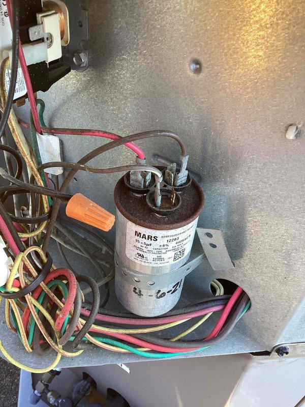 Responded to service call for dual commercial A/C system with one non-operational unit. Performed diagnostic testing using clamp meter to measure electrical values at the affected unit. Inspected capacitor, contactor, and associated wiring connections. Identified faulty MARS capacitor with improper readings. Replaced defective capacitor, verified all electrical connections, and tested unit operation to confirm proper function restored.