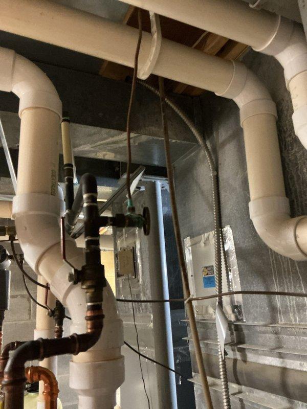 Responded to reported leak near recently installed spigot in mechanical room area. Upon arrival, isolated water supply to affected zone and documented conditions with photos showing PVC piping system, HVAC ductwork, and exposed framing in adjacent construction area. Advised customer this may be callback-related to previous installation work and will assess whether leak originated from recent spigot installation or separate plumbing issue requiring additional repair.