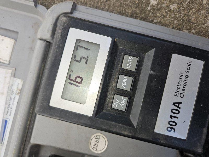 Completed maintenance service on 10-year-old air conditioning unit. Performed system diagnostics and utilized electronic charging scale to verify refrigerant levels and pressures were within manufacturer specifications. All measurements confirmed proper system operation and charge levels maintained at optimal parameters for continued efficient cooling performance.