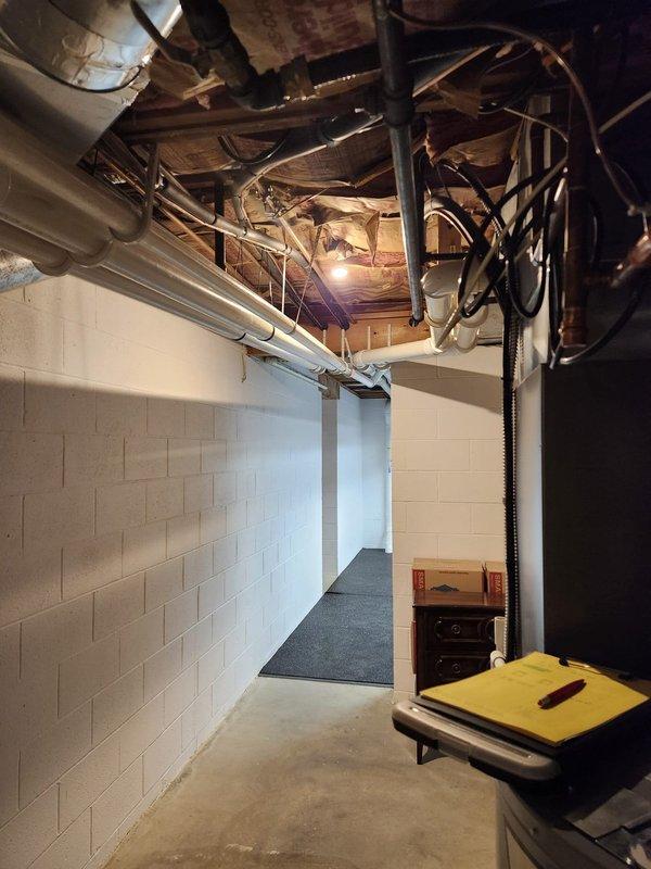 Completed AC retrofit installation in basement location. Installed new air conditioning system with evaporator coil, integrating equipment with existing ductwork and utility infrastructure in exposed ceiling space. System tested and verified operational upon completion.