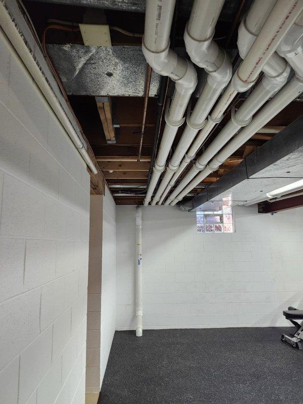 Completed AC retrofit installation in basement location. Installed new air conditioning system with evaporator coil, integrating equipment with existing ductwork and utility infrastructure in exposed ceiling space. System tested and verified operational upon completion.