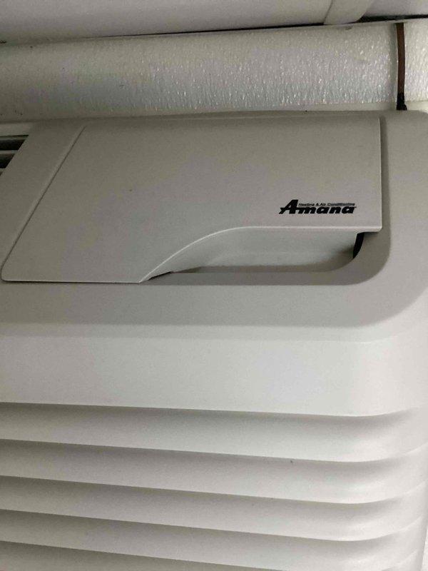 Responded to service call for commercial A/C unit not maintaining setpoint temperature, with thermostat set to 75°F but space reading 84°F. Upon arrival, inspected Amana PTAC unit and assessed system performance. Documented equipment condition and installation setup, noting unit mounted in corner location with visible refrigerant lines and electrical connections. System appears to require further diagnostics to determine cause of insufficient cooling capacity and temperature differential issue.