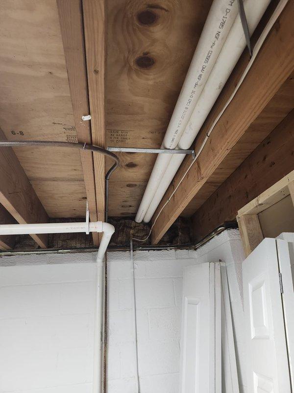 Completed full HVAC system retrofit in basement mechanical room, including new furnace and air conditioning equipment installation. Installed furnace unit with properly configured supply and return ductwork, mounted vertical plenum with integrated controls, and ran PVC condensate drain lines in accordance with manufacturer specifications. All ductwork secured to ceiling joists with appropriate fasteners, system tested and verified operational upon completion.