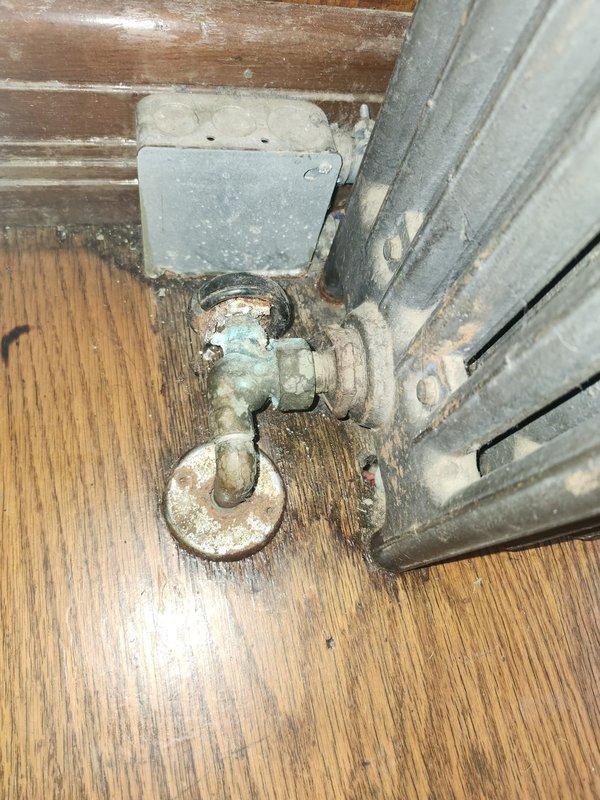 Responded to no heat complaint affecting two radiators. Found both radiator valves in closed position, opened valves and verified heat restoration to affected areas. Identified multiple system deficiencies requiring future attention: third radiator valve actively leaking, second radiator valve handle spinning freely without proper shut-off function, several nickel air bleeders stripped, backflow fill valve assembly seeping water, and corroded union fitting above boiler showing signs of leakage. Customer declined immediate repairs and will schedule service in spring season.