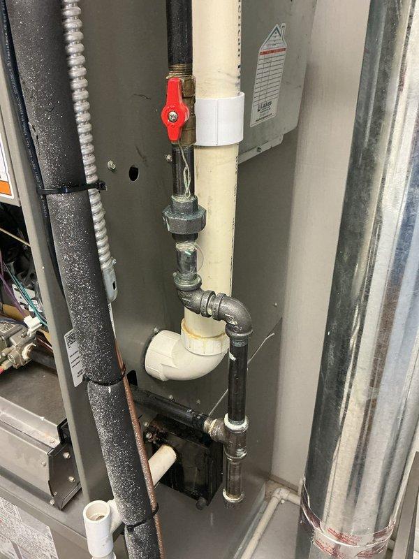 Responded to callback for unresolved gas leak on furnace supply line. Upon arrival, inspected gas piping assembly and fittings at furnace connection point. Located active leak at threaded union connection between galvanized steel pipe and brass valve assembly. Applied leak detection solution to verify exact leak location at threaded joint. Shut off gas supply via red-handled ball valve, depressurized line, and disassembled union fitting. Cleaned threads, applied appropriate pipe thread sealant, and reassembled connection to manufacturer specifications. Pressurized system and performed leak check with soap solution—no leaks detected. Restored gas supply and verified proper furnace operation.