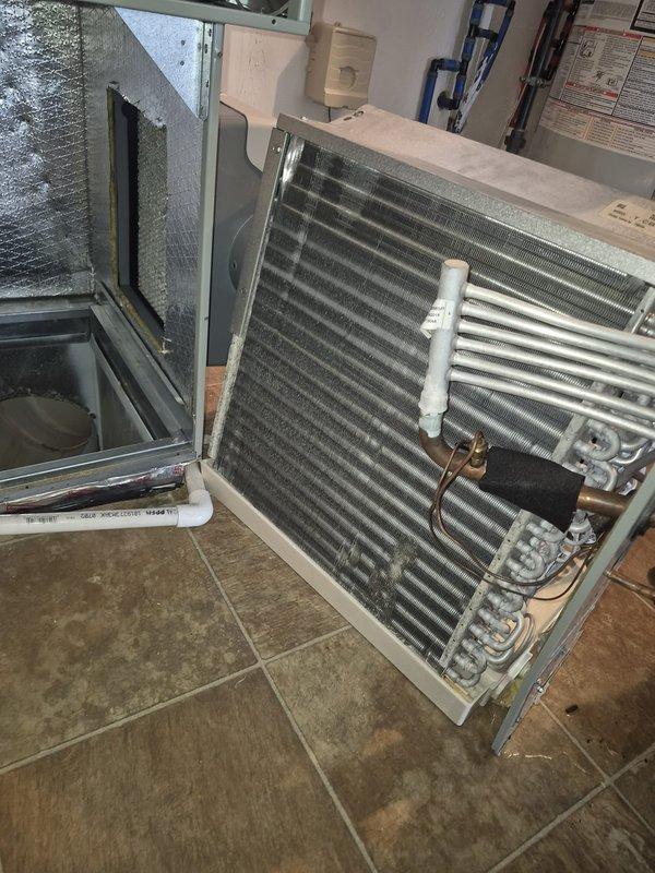 Performed diagnostic service and removed evaporator coil from air handling unit to allow access for third-party duct cleaning service. Disconnected refrigerant lines and removed coil assembly from unit, securing all components for reinstallation upon completion of duct cleaning work.