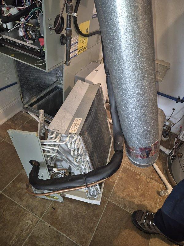 Performed diagnostic service and removed evaporator coil from air handling unit to allow access for third-party duct cleaning service. Disconnected refrigerant lines and removed coil assembly from unit, securing all components for reinstallation upon completion of duct cleaning work.