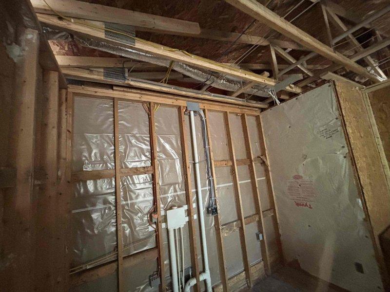 Completed rough-in HVAC ductwork installation for new construction addition, including flexible and rigid metal duct runs for rear addition spaces, storage room off garage, bedroom, and garage heater. Installed metallic flex duct through ceiling joists and sheet metal plenum transitions, properly secured all ductwork to framing members, and coordinated routing to avoid interference with structural elements and electrical systems.