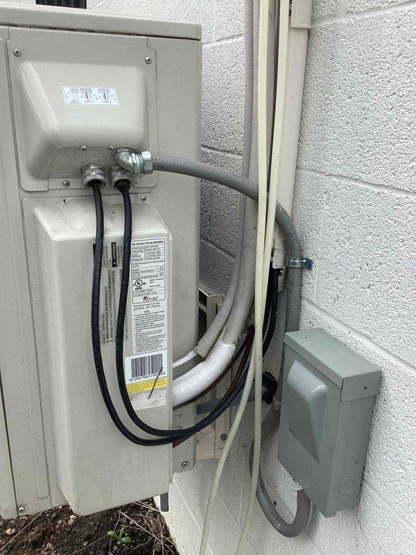 Responded to callback for wall-mounted AC unit with recurring cooling issue from previous month. Upon inspection, found unit operational but delivering insufficient cool air, consistent with reported symptoms. Performed diagnostic testing of indoor evaporator coil, refrigerant levels, and electrical connections at outdoor disconnect panel. Documented existing water staining above indoor unit indicating potential condensate drainage concerns that may be contributing to performance issues.