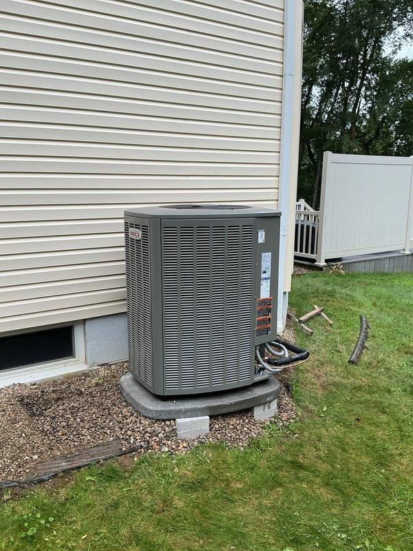 Relocated outdoor Lennox air conditioning condenser unit 6 inches away from exterior wall to improve airflow clearance and comply with manufacturer specifications. Repositioned unit on existing concrete pad with proper leveling, maintained refrigerant line connections, and verified system operation upon completion.