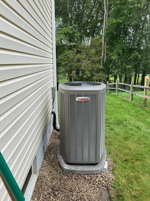 Relocated outdoor Lennox air conditioning condenser unit 6 inches away from exterior wall to improve airflow clearance and comply with manufacturer specifications. Repositioned unit on existing concrete pad with proper leveling, maintained refrigerant line connections, and verified system operation upon completion.