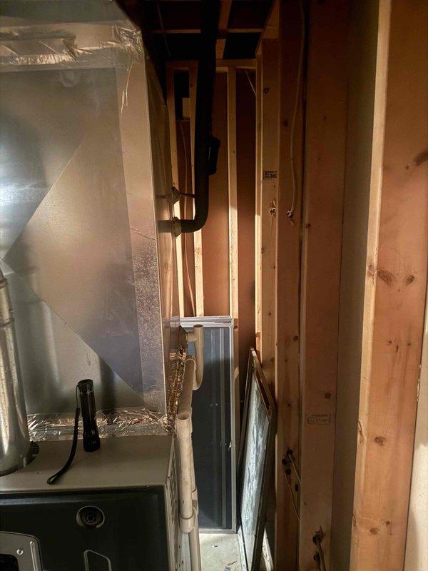 Performed dye search inspection on HVAC system to identify potential refrigerant leak. Inspected furnace unit, ductwork, and refrigerant lines in basement mechanical room using UV dye detection method, documenting findings with photographs of equipment and copper piping installations for further analysis.