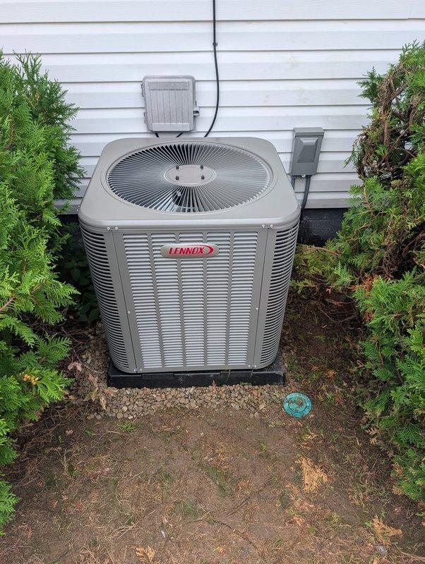 # A/C Retrofit Installation Completed

Successfully completed air conditioning retrofit installation on residential Lennox condensing unit. Installed new outdoor condenser with proper placement on composite pad against exterior wall with appropriate clearances. Ran refrigerant lines and electrical conduit along exterior siding to junction box and disconnect switch. Charged system with R-484B refrigerant and performed comprehensive system diagnostics.

System testing confirmed optimal performance parameters: low side temperature at 67.2°F, high side temperature at 80.0°F, vapor saturation temperature at 51.8°F, and liquid saturation temperature at 86.6°F. Measured superheat at 15.4°F and subcool at 8.6°F, both within manufacturer specifications and system targets. All electrical connections secured and tested. Unit operating efficiently with proper airflow through top-mounted fan assembly. Performed preventive maintenance inspection to ensure long-term reliability. Installation complete
