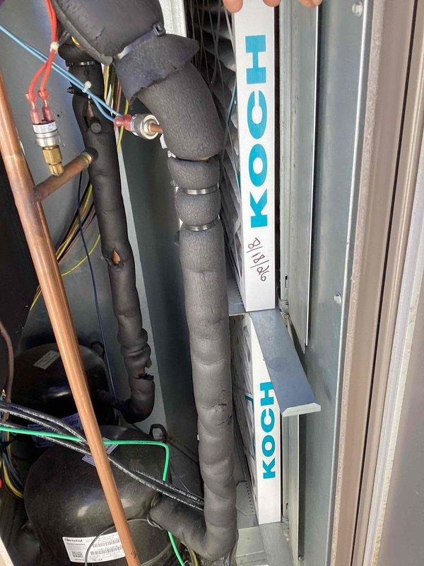 Completed scheduled commercial cooling maintenance on York rooftop package unit. Performed comprehensive inspection of exterior cabinet, condenser coil section, and internal components including refrigerant lines, electrical connections, and insulated suction lines. Verified all access panels secure, examined copper refrigerant piping and brass fittings for proper connections, and confirmed system operational status with no significant issues identified during routine service visit.