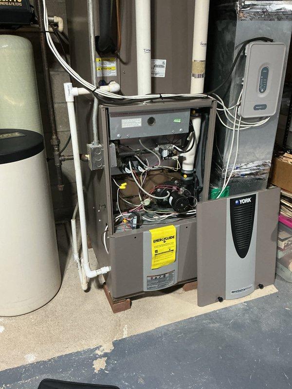 Completed full HVAC system retrofit including furnace and air conditioning replacement at residential property. Installed new York furnace unit in basement mechanical room with proper electrical connections, ductwork integration, and venting. Replaced outdoor condensing unit on existing concrete pad with updated equipment, ensuring proper refrigerant line connections and electrical service. Verified all mechanical systems operational, tested heating and cooling cycles, and confirmed proper airflow throughout the system.