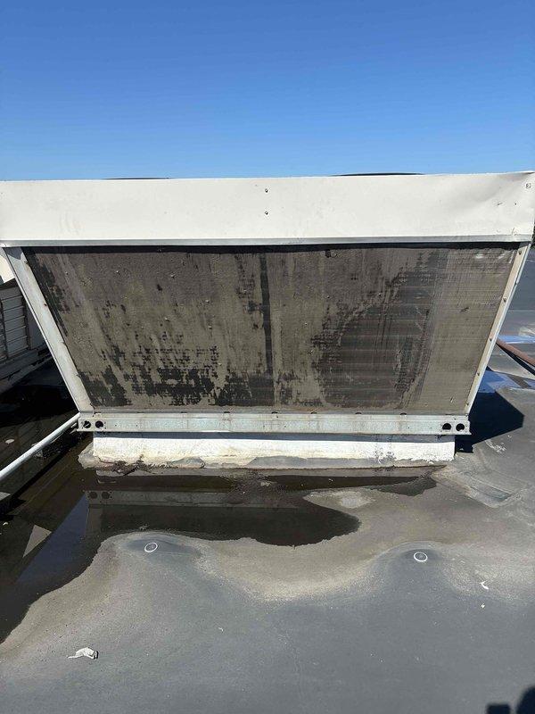 Completed scheduled commercial cooling maintenance on rooftop HVAC unit. Inspected equipment and found both air filters heavily contaminated with accumulated dirt, dust, and debris showing significant discoloration. Accessed unit housing, documented filter condition, and inspected internal ductwork components including support frame and mounting hardware. Unit operational at time of service with no immediate mechanical issues noted beyond required filter maintenance.
