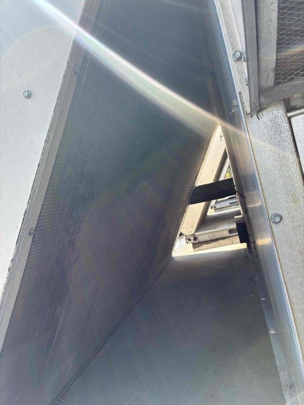 Completed scheduled commercial cooling maintenance on rooftop HVAC unit. Inspected equipment and found both air filters heavily contaminated with accumulated dirt, dust, and debris showing significant discoloration. Accessed unit housing, documented filter condition, and inspected internal ductwork components including support frame and mounting hardware. Unit operational at time of service with no immediate mechanical issues noted beyond required filter maintenance.