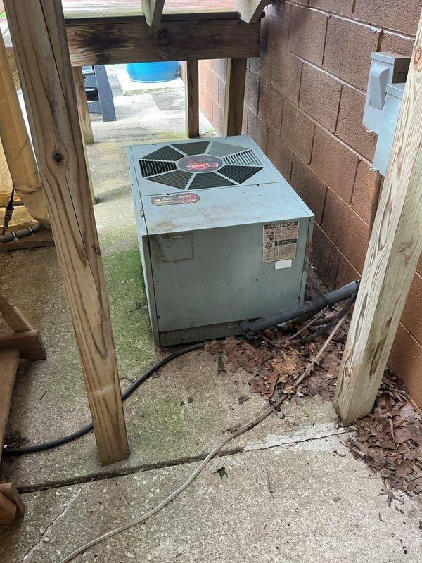 Completed full HVAC system retrofit including furnace and air conditioning replacement. Installed new gray furnace unit in basement mechanical room with proper ductwork connections, PVC venting, and condensate pump system. Replaced outdoor air conditioning condenser unit with new equipment positioned on existing concrete pad in covered under-deck area, utilizing proper electrical conduit and refrigerant line connections. Both units installed to manufacturer specifications with all required safety labels and technical documentation affixed.