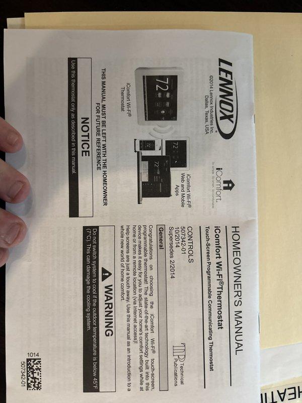 Responded to emergency service call for non-functioning thermostat with blank display while air conditioning unit continued to operate. Diagnosed Lennox iComfort Wi-Fi thermostat (Model 1DF81) experiencing complete display failure on seven-year-old system. Removed thermostat from wall plate to inspect unit and verify model specifications including serial number and hardware/software version. Provided homeowner with manufacturer documentation and operating manual for future reference. System evaluation completed and homeowner advised of findings.