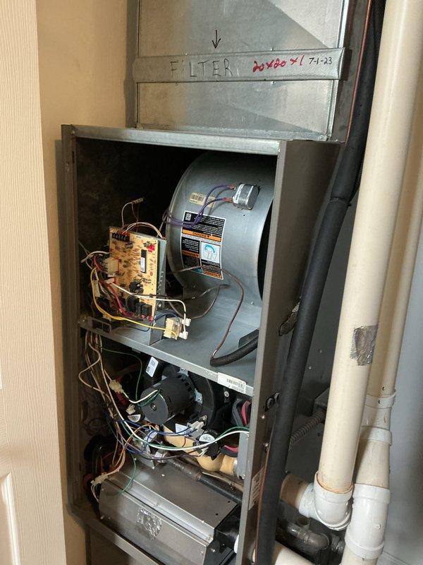 Completed A/C retrofit installation in utility closet, replacing existing HVAC system with new vertical cabinet unit featuring integrated humidification system. Installed drum-style humidifier assembly, configured control board wiring and electrical connections, and established PVC drainage piping with valve controls to ensure proper condensate management and water supply for humidification functionality.