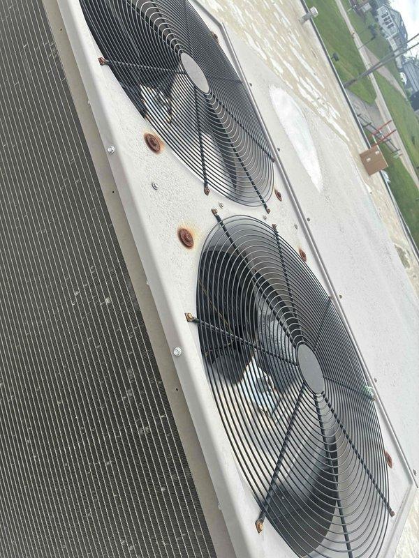 Responded to commercial HVAC maintenance contract call for rooftop unit experiencing condenser fan failure. Upon arrival, performed diagnostic assessment and confirmed condenser fan motor was inoperative. Using digital multimeter, verified electrical readings and determined motor had failed and required replacement. Removed defective condenser fan motor, fan blade assembly, and run capacitor from outdoor condensing unit. Installed new OEM-equivalent condenser fan motor with proper voltage and amperage specifications. Mounted new fan blade with correct pitch and secured with appropriate hardware. Replaced run capacitor to ensure optimal motor performance and longevity. Verified all electrical connections were properly terminated and secured. Energized unit and confirmed condenser fan motor operated within manufacturer specifications at 96.2 volts. System tested and left in normal operating condition.