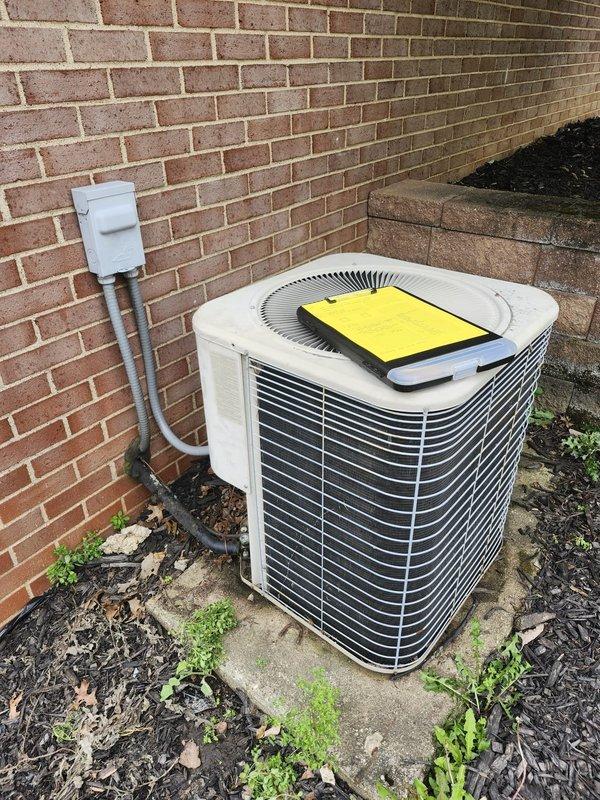 Completed full residential air conditioning system replacement. Installed new Lennox outdoor condenser unit on existing concrete pad adjacent to building foundation, connected to electrical disconnect box via conduit. Unit properly positioned and leveled with all refrigerant lines, electrical connections, and condensate drainage completed to manufacturer specifications. Indoor air handler integrated with existing furnace system, with all ductwork transitions and PVC drain lines secured and tested for proper operation. System startup performed, refrigerant charge verified, and all safety controls confirmed functional.