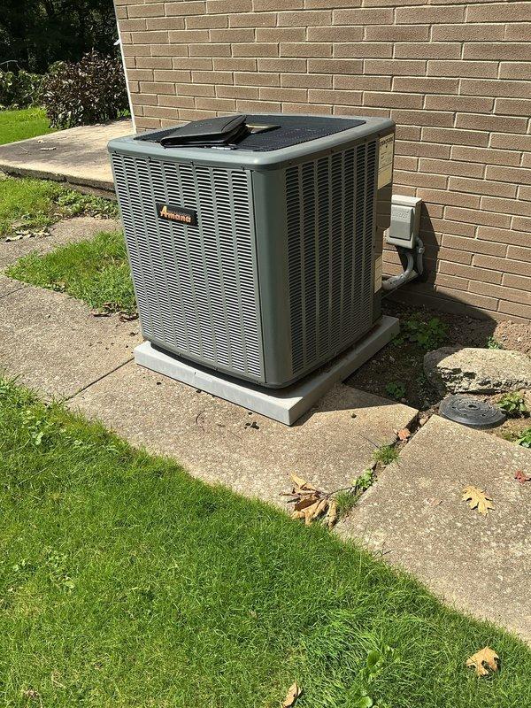 Completed full HVAC system retrofit involving furnace and air conditioning replacement at residential property. Installed new Amana air conditioning condenser unit on exterior concrete pad with proper electrical disconnect and positioning for optimal ventilation and service access. Replaced indoor furnace unit in basement utility area with new forced-air heating system, including installation of white PVC condensate drainage and venting piping. Connected metal supply plenum and ductwork to new furnace cabinet. Verified all electrical connections, control board operation, and proper system integration between indoor and outdoor components. Both units positioned and secured according to manufacturer specifications with access panels available for future maintenance and service.