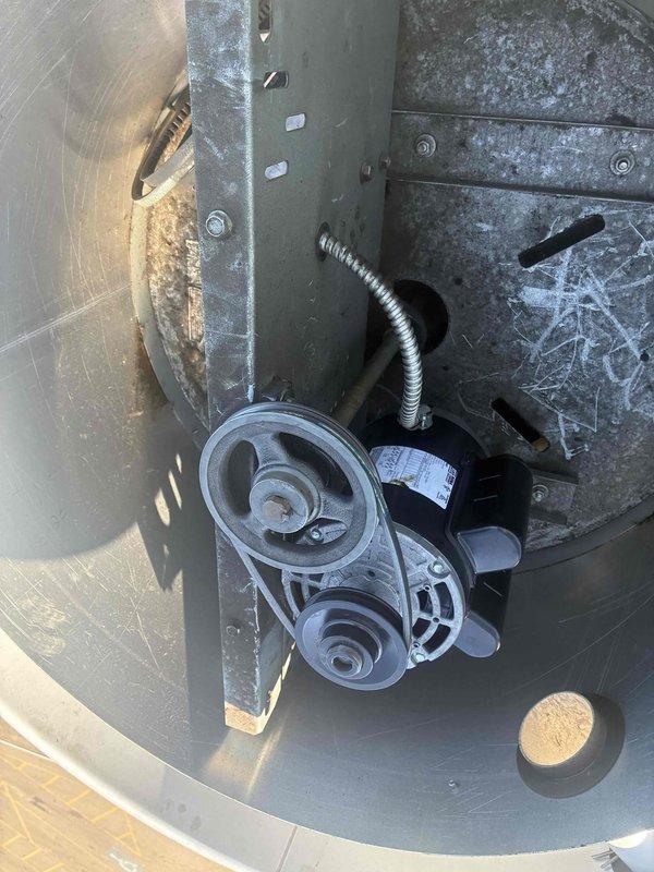 Responded to service call for commercial kitchen exhaust fan serving fryer equipment that was making loud noise before failing completely. Upon inspection, found belt-driven exhaust fan system with excessive dust and grease accumulation on pulleys, motor housing, and surrounding components. Diagnosed failed drive belt and worn pulley system as cause of operational failure. Cleaned mechanical assembly, replaced drive belt, inspected motor and pulley alignment, and verified proper tension. Tested system operation and confirmed exhaust fan running smoothly with no abnormal noise.