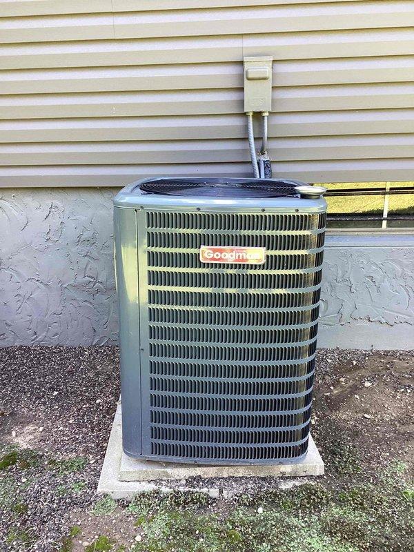 Completed routine commercial cooling maintenance on two Goodman condenser units as part of recurring service contract. Inspected both units, noting significant algae and organic growth accumulation on exterior coil fins of one unit, which can restrict airflow and reduce heat exchange efficiency. Verified both units operational and level on concrete pads, documented equipment condition with photographs for service records.