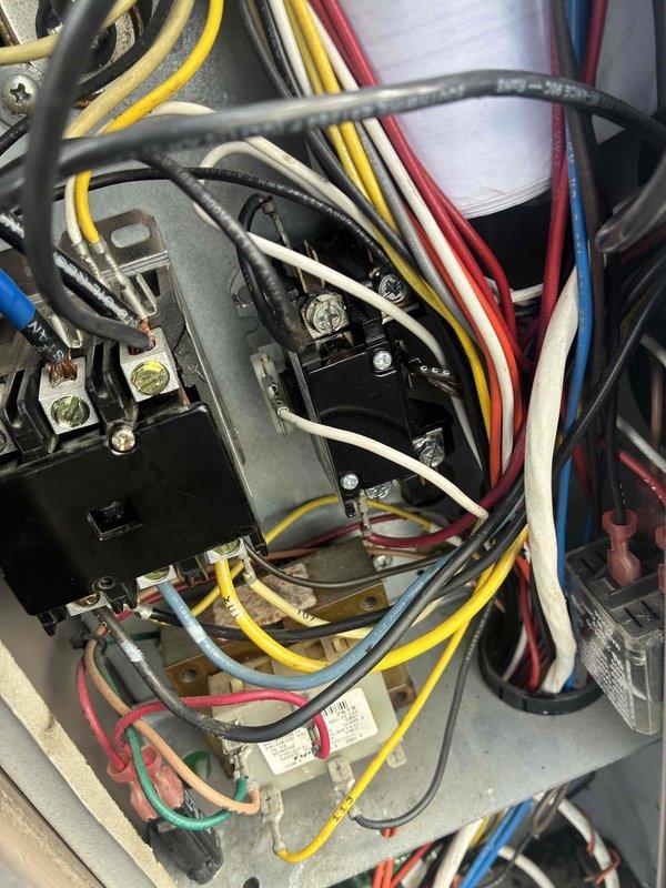 Responded to callback for non-operational unit following recent condenser fan motor replacement. Upon arrival, inspected electrical control panel and verified all wiring connections to contactor, capacitor, and newly installed motor were secure and properly terminated. Checked thermostat programming and confirmed system settings were correct with setpoint at 77°F and scheduled temperature range of 67-70°F. Cycled system through complete operational test, verified proper startup sequence, and confirmed unit is now cooling effectively with all components functioning as designed.