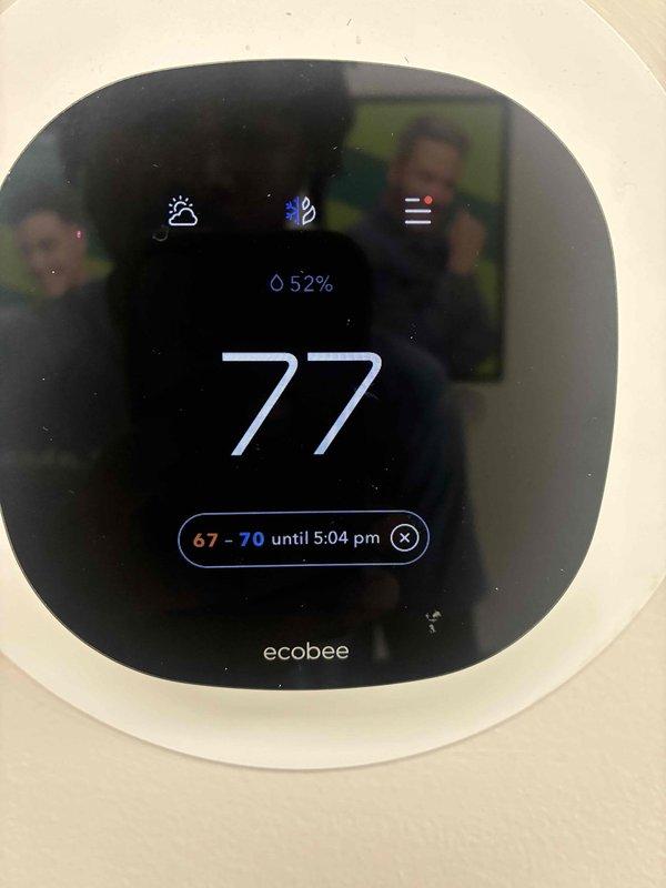 Responded to callback for non-operational unit following recent condenser fan motor replacement. Upon arrival, inspected electrical control panel and verified all wiring connections to contactor, capacitor, and newly installed motor were secure and properly terminated. Checked thermostat programming and confirmed system settings were correct with setpoint at 77°F and scheduled temperature range of 67-70°F. Cycled system through complete operational test, verified proper startup sequence, and confirmed unit is now cooling effectively with all components functioning as designed.